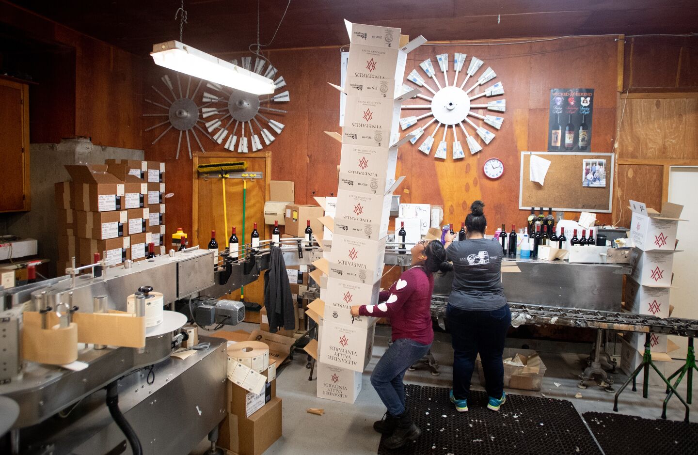 A cellar worker carries a stack of boxes on the production line at Alexander Valley Vineyards. Hank Wetzel had never sought to export wines until he visited China two years ago.