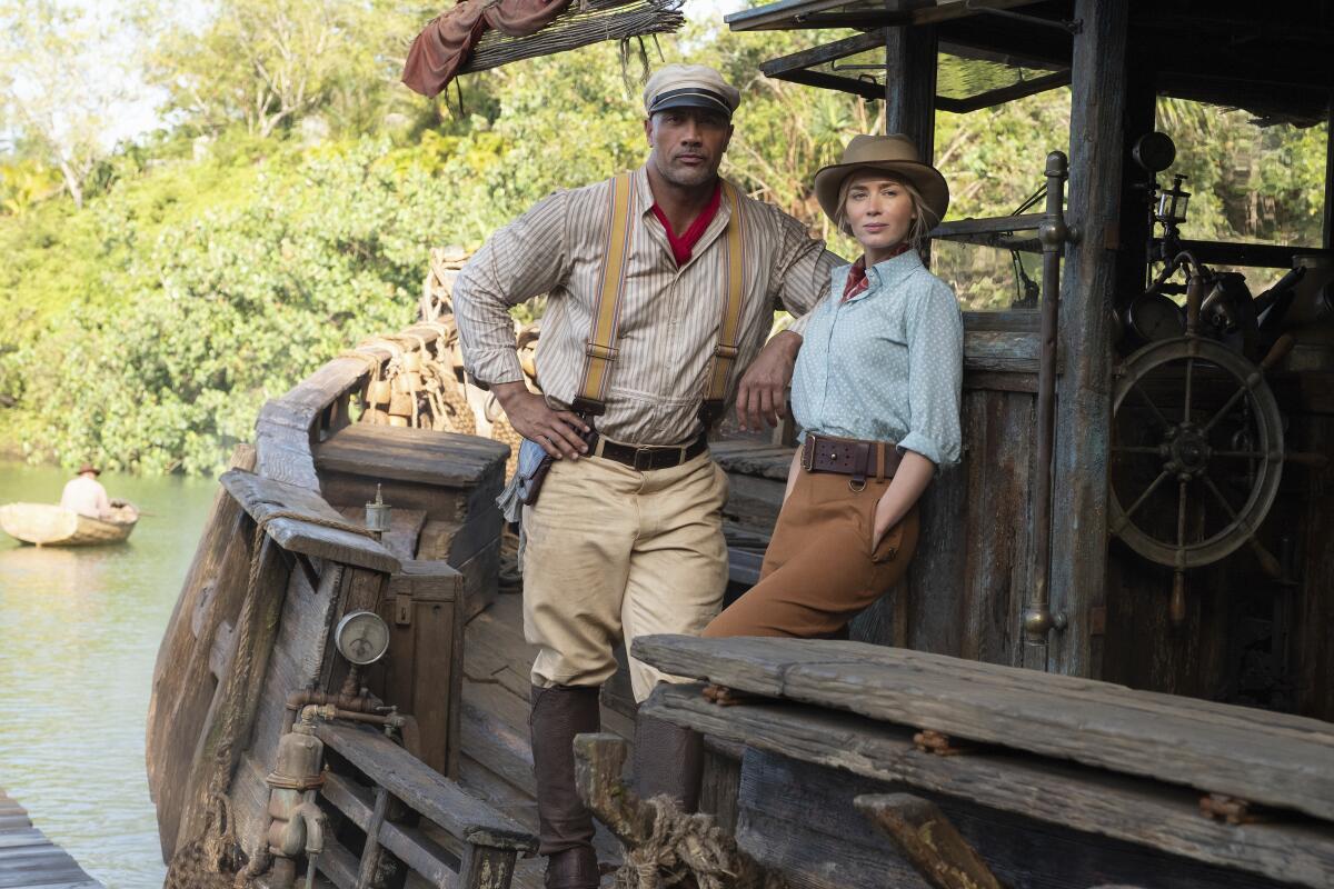 Dwayne Johnson and Emily Blunt on a boat in "Jungle Cruise."