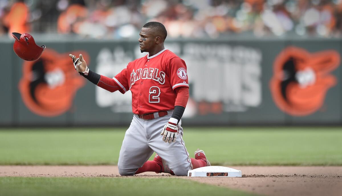 Angels shortstop Erick Aybar tosses his helmet after getting tagged out during a double play in the seventh inning Sunday in Baltimore.