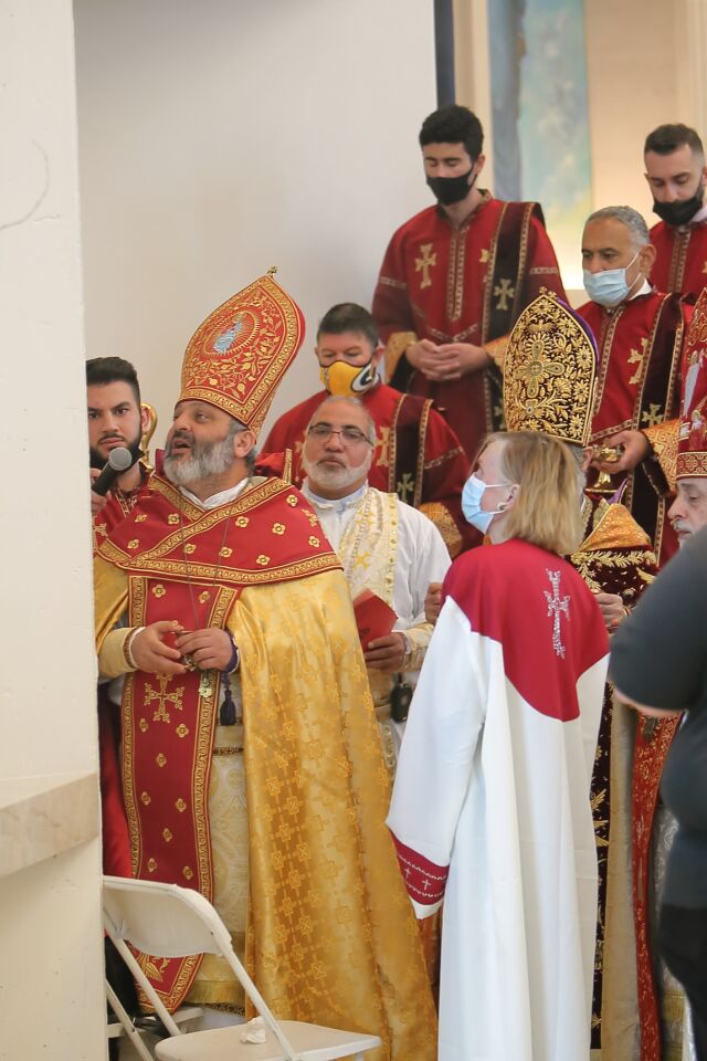 Bishop Bagrat Galastanyan (Primate of the Diocese of Tavush, Armenia) anoints one of the crosses around the sides of the sanctuary