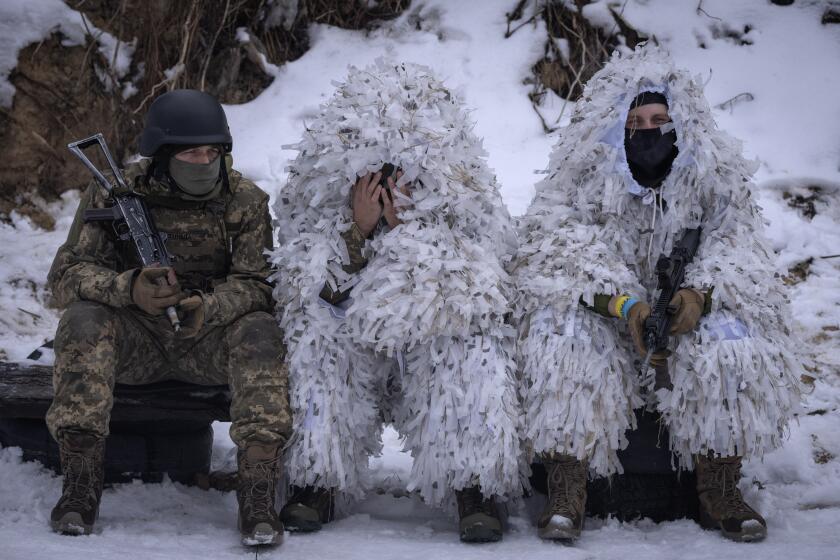 Members of the pro-Ukrainian Russian ethnic Siberian Battalion rest at a military training close to Kyiv, Ukraine, Wednesday, Dec. 13, 2023. Ukraine's military has formed a battalion of soldiers made up entirely of Russian citizens who want to fight against Russian invasion.(AP Photo/Efrem Lukatsky)