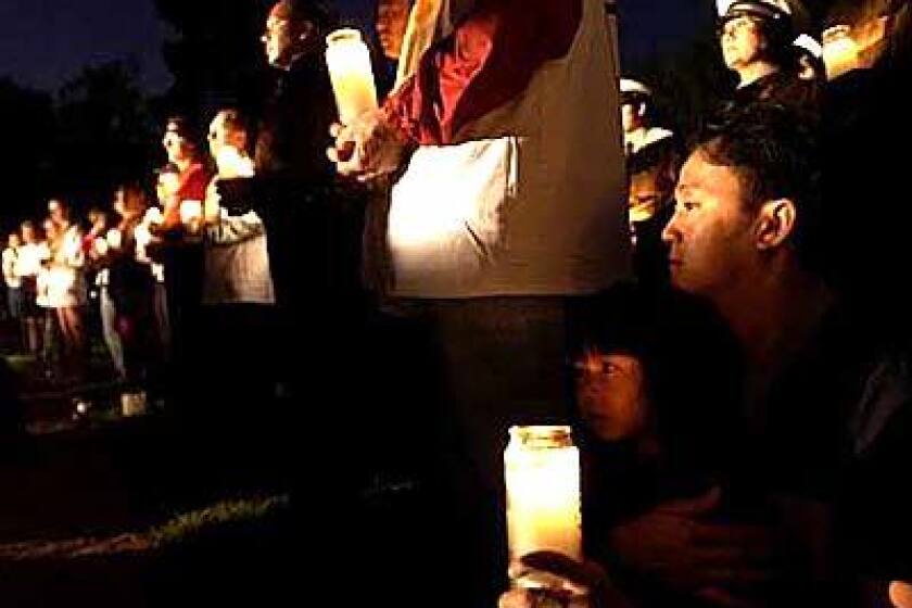 Residents joined fire and police officials during an early-morning candlelight memorial service at North Hollywood Park.