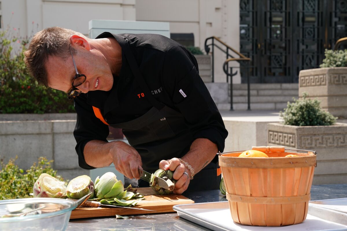 Brian Malarkey trims an artichoke during a quickfire challenge during the premiere episode of "Top Chef: All-Stars," airing Thursday, March 19, on Bravo network.