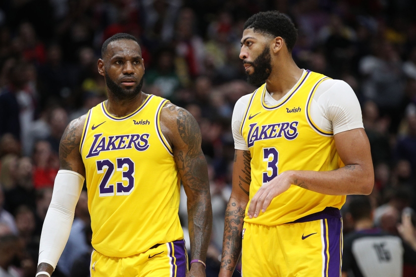 Anthony Davis and LeBron James in Los Angeles Lakers uniforms on court. 