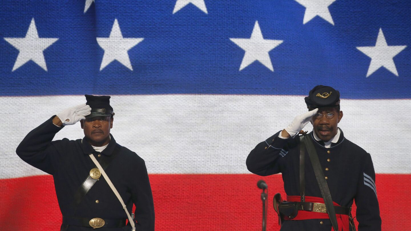 Members of the 3rd Regiment Intantry United States Colored Troops conduct the presentation of the colors on the final of the Democratic National Convention in Philadelphia.