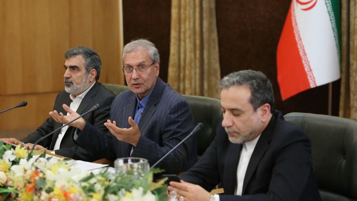 Iran's Atomic Energy Organization spokesman Behrouz Kamalvandi, left, government spokesman Ali Rabiei and Deputy Foreign Minister Abbas Araghchi address the press in Tehran on Sunday.