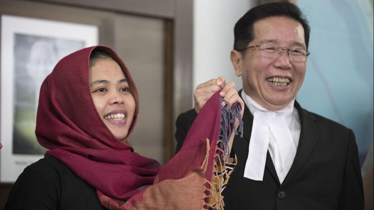 Siti Aisyah smiles with her lawyer Gooi Soon Seng after a news conference at the Indonesian Embassy in Kuala Lumpur, Malaysia, on March 11.