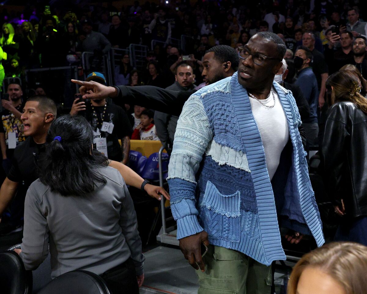 Shannon Sharpe walks away from the court after getting into a verbal altercation with Memphis Grizzlies players.