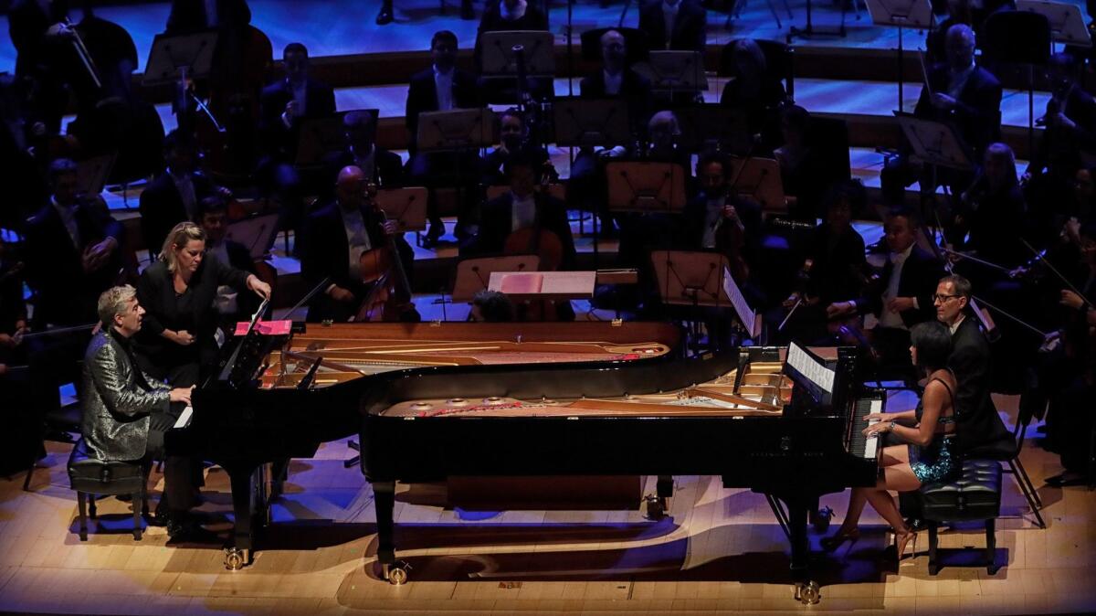 Pianists Jean-Yves Thibaudet and Yuja Wang perform an encore at the Los Angeles Philharmonic gala Tuesday night in Walt Disney Concert Hall.