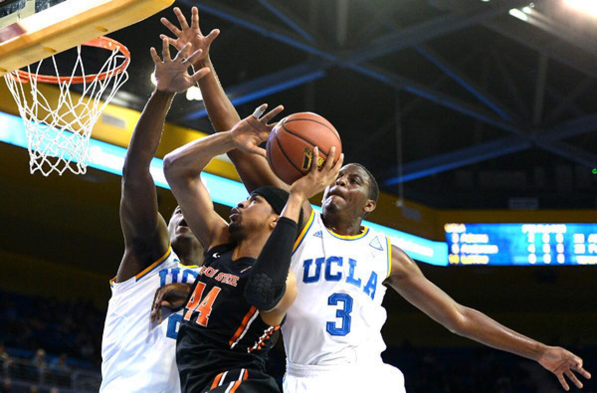 UCLA center Tony Parker and guard Jordan Adams (3) try to block a shot by Oregon State forward Devon Collier during a game Sunday at Pauley Pavilion.