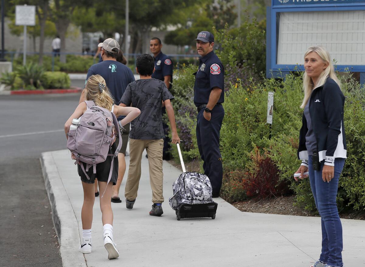 Kids are welcomed to the first day of school by members of the Laguna Beach Fire Department ambulance crews at Thurston.