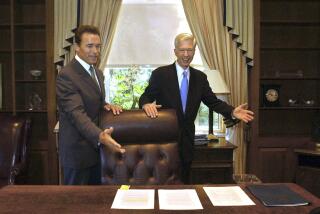 FILE — In this Oct. 23, 2003 file photo, Gov.-elect Arnold Schwarzenegger, left, and Gov. Gray Davis joke with each other as Davis shows Schwarzenegger the governor's private office at the Capitol in Sacramento, Calif. The two met for the first time since the voters elected Schwarzenegger to replace Gov. Gray Davis in the historic 2003 recall election. Today's California electorate is less Republican and more Asian and Latino than it was 18 years ago, trends that favor Newsom. (AP Photo/Rich Pedroncelli, File)