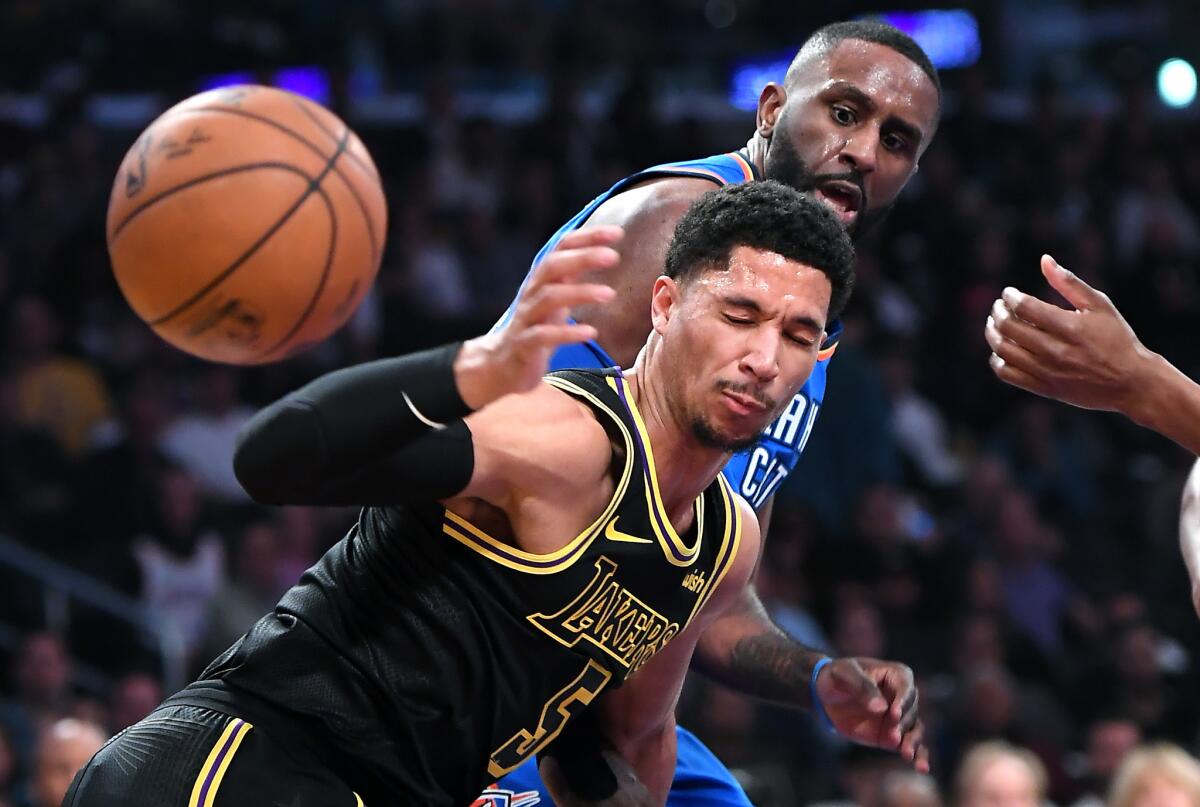 Lakers guard Josh Hart battles for a loose ball with Thunder forward Patrick Patterson during a game at Staples Center.