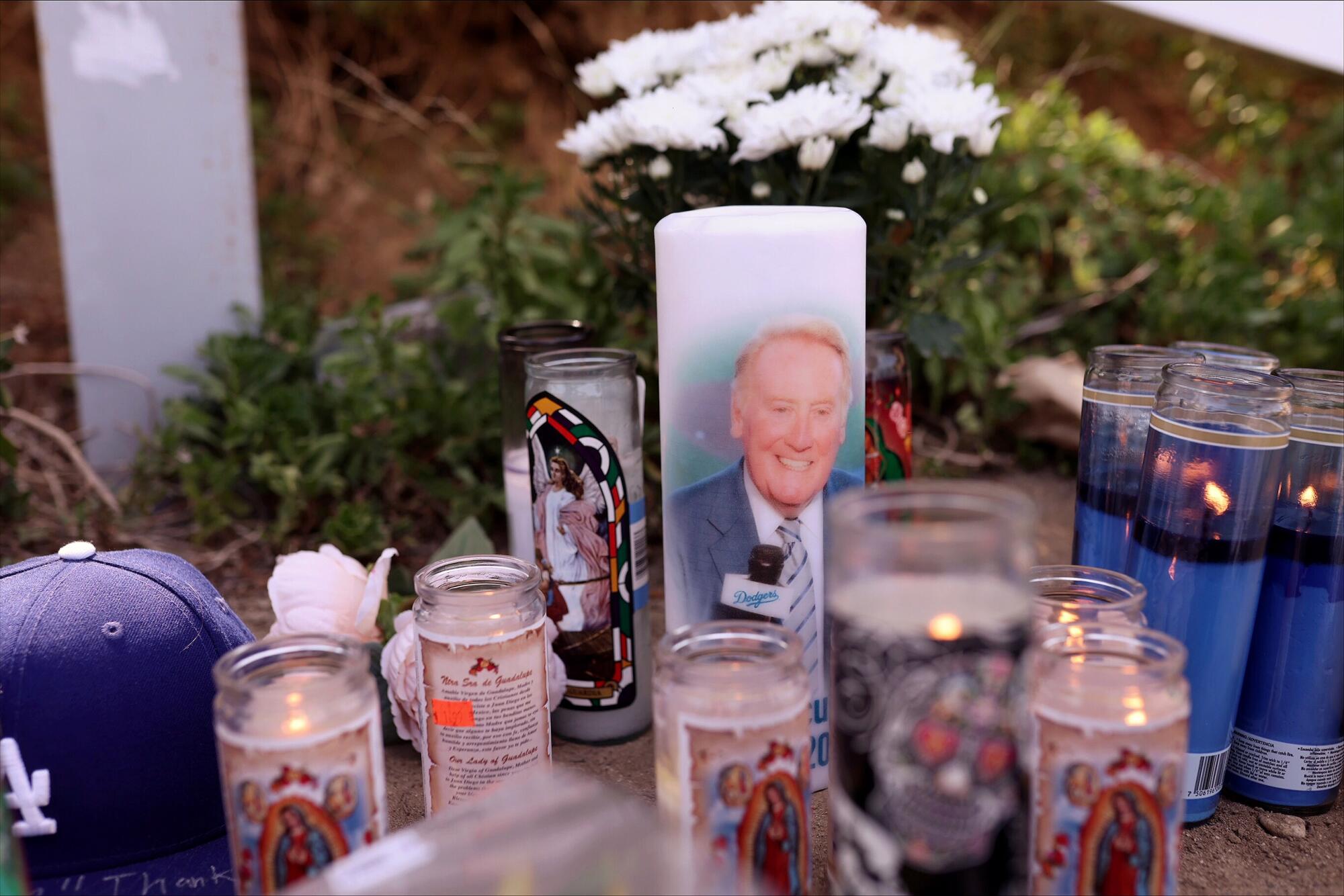 Candles burn at the Scully memorial outside Dodger Stadium 