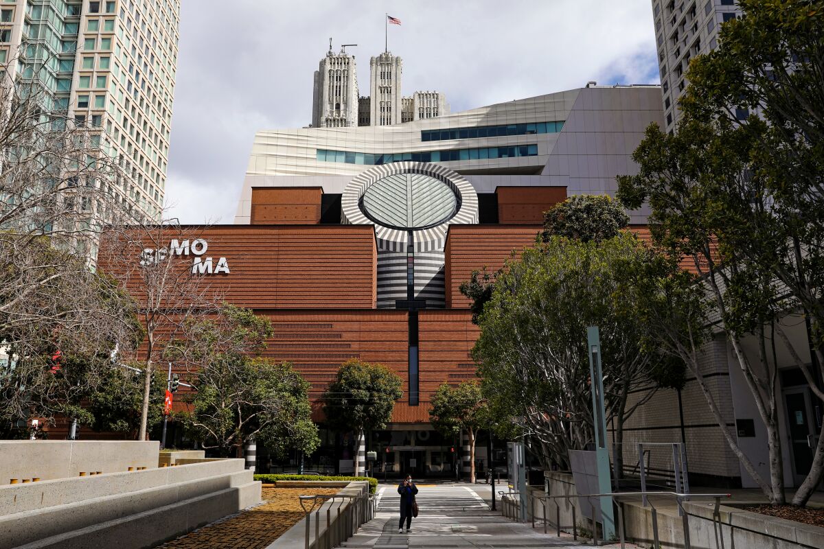 A view of the facade of SFMOMA bearing the name of the museum on red brick.
