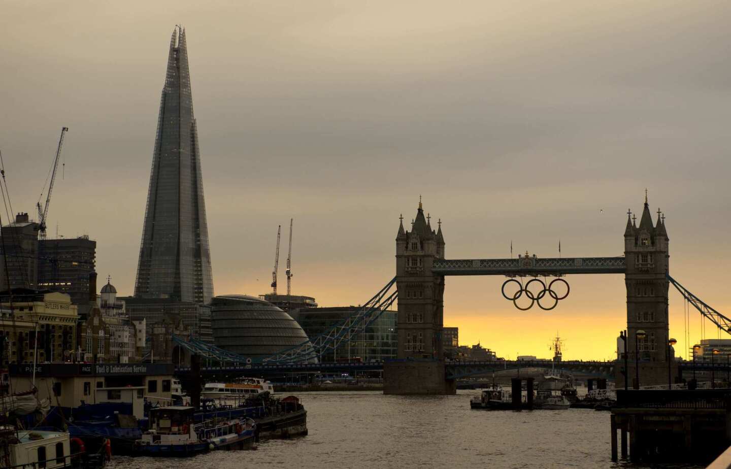 The sun sets behind the Tower Bridge, hours before the the opening ceremony of the 2012 London Olympic Games.