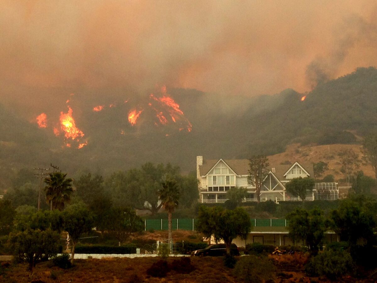Fire comes close to homes in the hills above Hidden Valley in Thousand Oaks.
