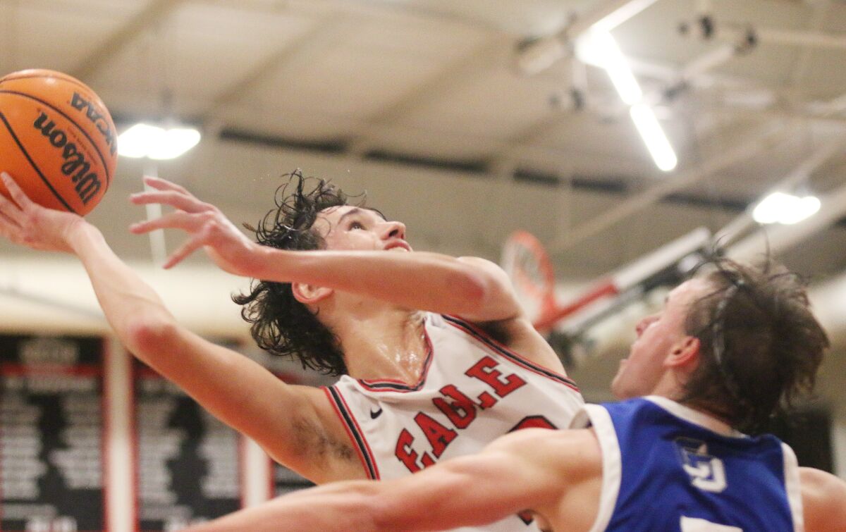 Senior Daniel Greathouse maneuvers at the rim.