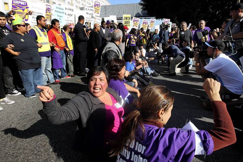 Demonstrators block an intersection near Los Angeles International Airport on Wednesday, the day before Thanksgiving. An LAX spokesperson said the protest caused congestion initially, but, "once we started rerouting people, it started to get moving."