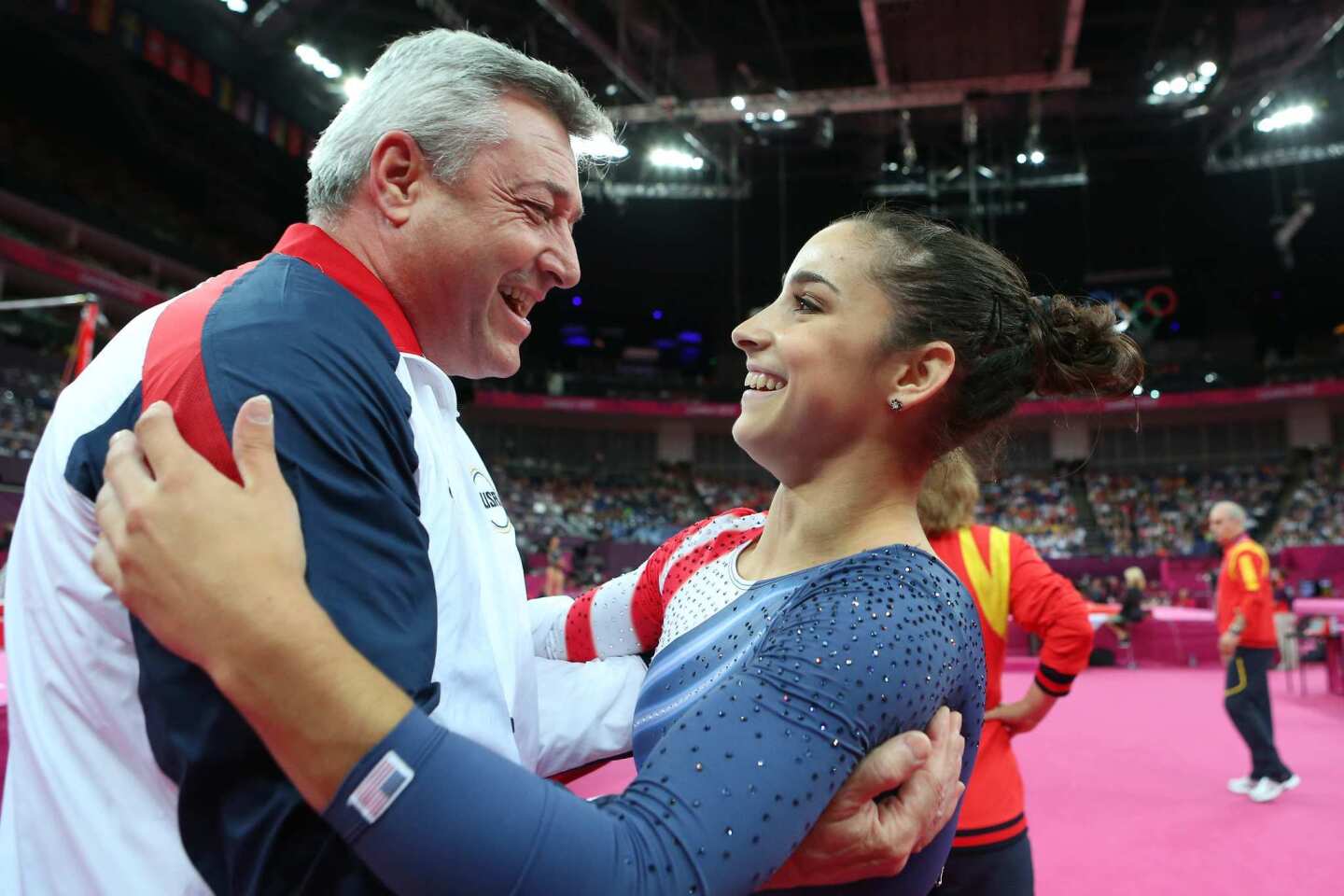 Aly Raisman of the United States hugs coach Mihai Brestyan after winning the gold medal in the floor exercise.