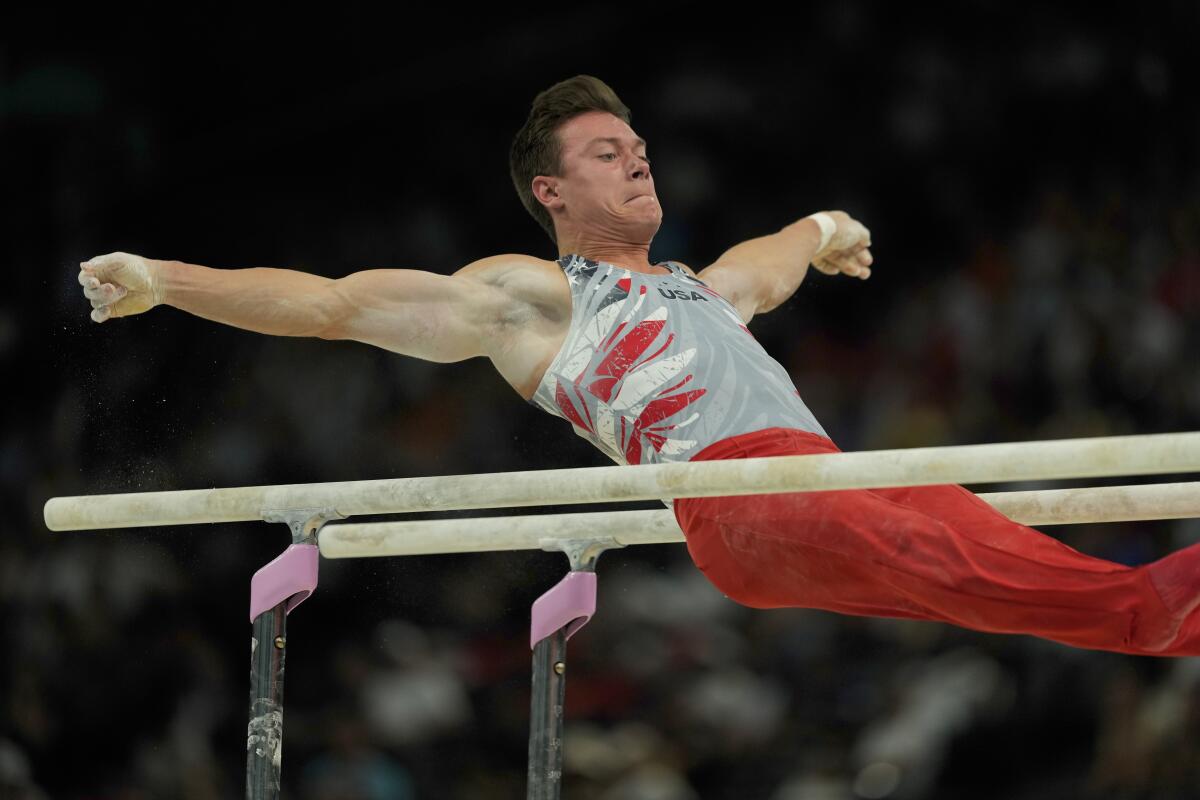 Brody Malone, of the U.S., performs on the parallel bars during the gymnastics team finals round at the Summer Olympics 