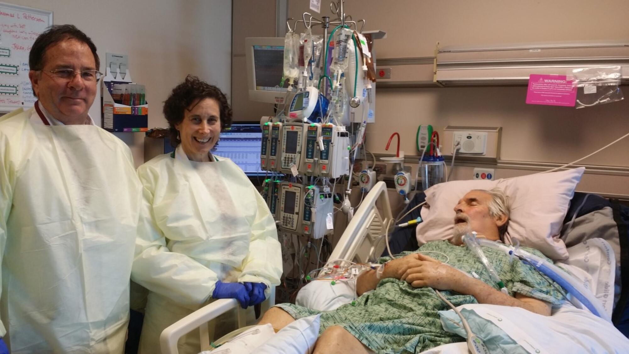 Chip Schooley (left) and Dr. Randy Taplitz helped save UCSD researcher Tom Patterson (in bed) in 2016.