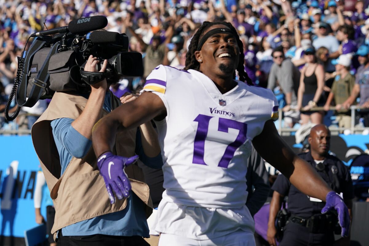 Minnesota Vikings wide receiver K.J. Osborn (17) celebrates makeing the game-winning catch against the Carolina Panthers during overtime of an NFL football game, Sunday, Oct. 17, 2021, in Charlotte, N.C. The Minnesota Vikings won 34-28. (AP Photo/Gerald Herbert)