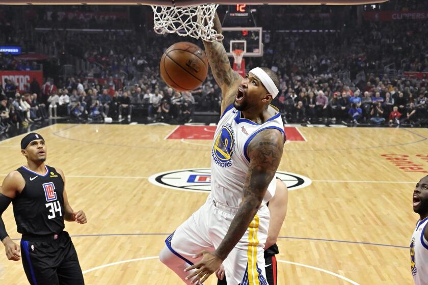 Golden State Warriors center DeMarcus Cousins, center, dunks as Los Angeles Clippers forward Tobias Harris, left, and Warriors forward Draymond Green watch during the first half of an NBA basketball game Friday, Jan. 18, 2019, in Los Angeles. (AP Photo/Mark J. Terrill)