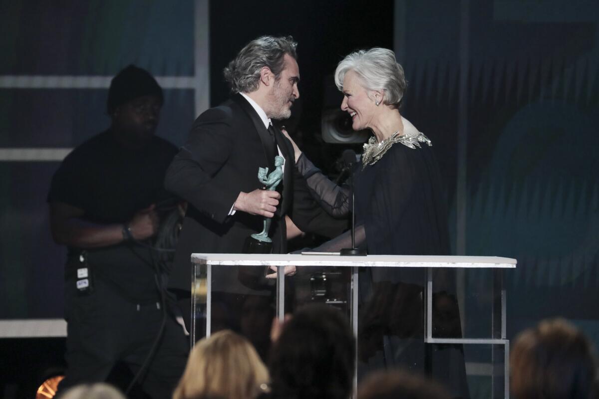 "Joker" star and SAG Awards winner Joaquin Phoenix accepts the lead actor prize from Glenn Close.
