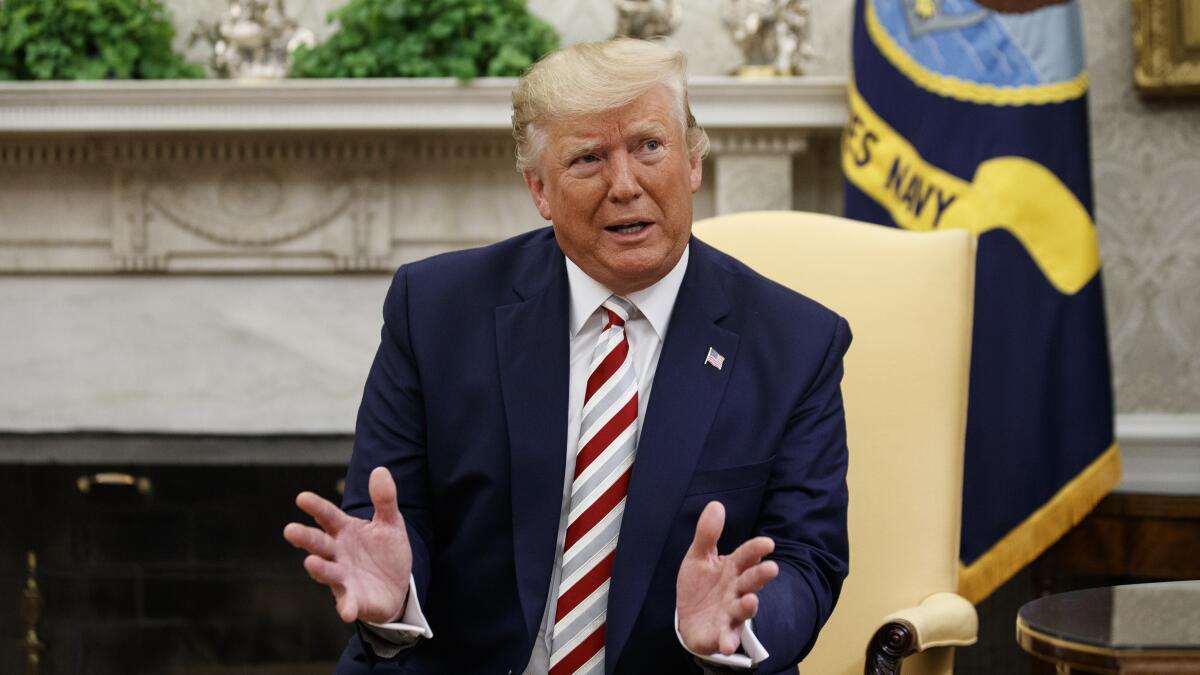 President Trump speaks to the media about recession fears and tax cuts during a meeting with Romanian President Klaus Iohannis in the Oval Office of the White House on Tuesday.