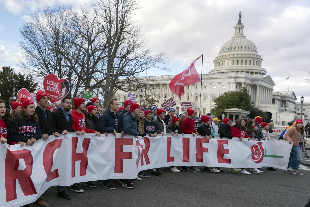 Marcherse outside the Capitol in Washington hold a banner reading "March for Life."