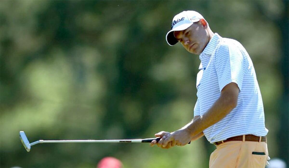 Bill Haas, the clubhouse leader with a four-under-par 68 on Thursday in the first round of the Masters, eyes his put on the 17th green at Augusta National Golf Club.