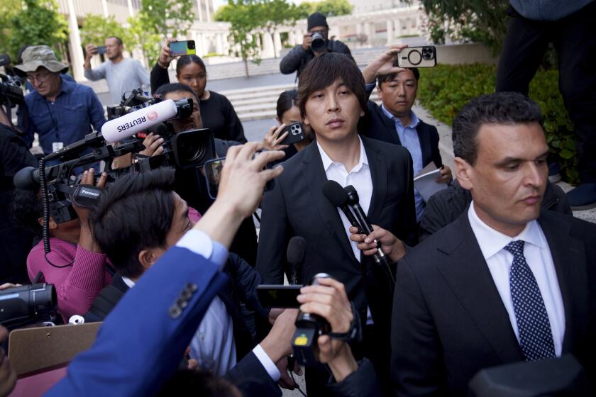 Ippei Mizuhara is surrounded by media as he leaves federal court following his arraignment on Tuesday