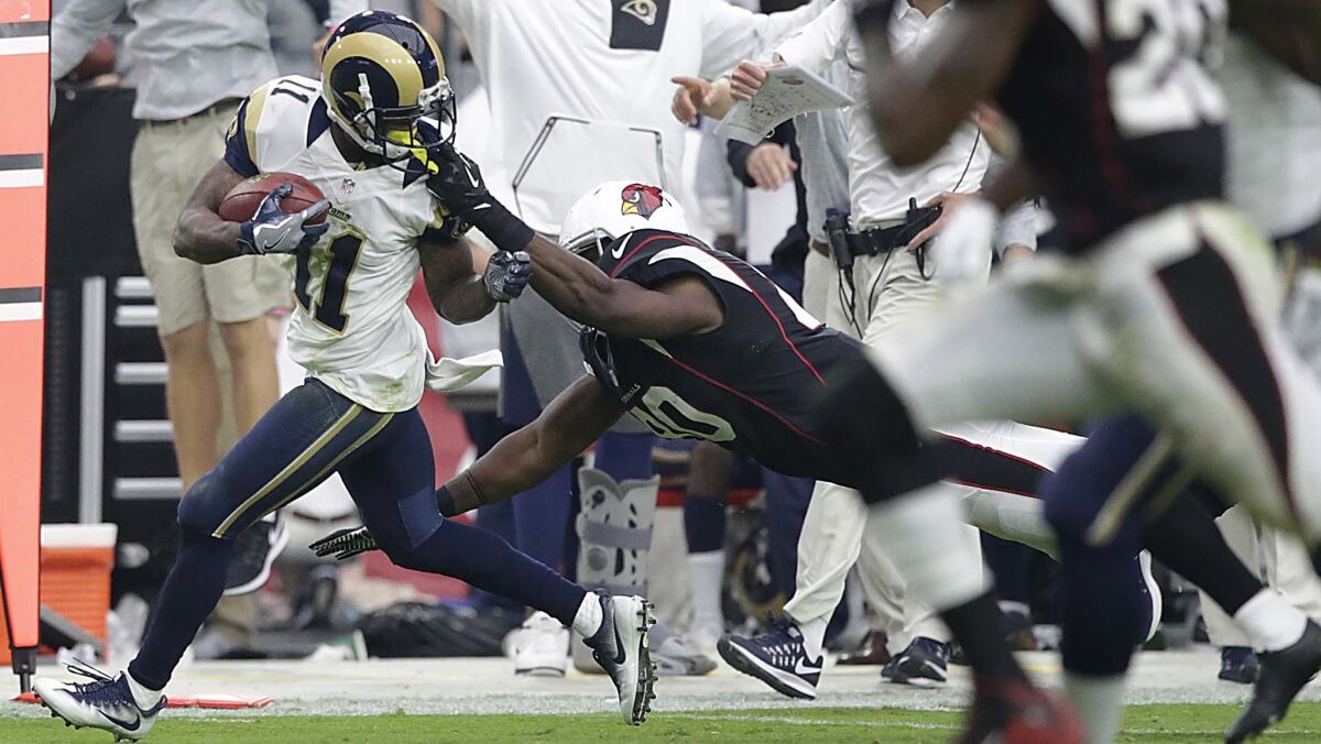 Rams punt returner Tavon Austin is pulled down by the facemask by Cardinals tight end Ifeanyi Momah, giving the Rams good field position for a fourth-quarter drive Sunday.