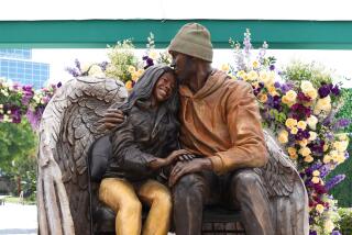 A new statue honoring Kobe and Gianna Bryant is on display outside Crypto.com Arena.