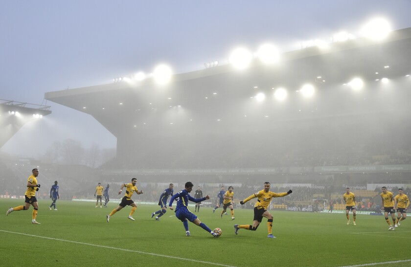 Fog envelopes the field during the English Premier League soccer match between Wolverhampton Wanderers and Chelsea at Molineux stadium in Wolverhampton, England, Sunday, Dec. 19, 2021. (AP Photo/Rui Vieira)