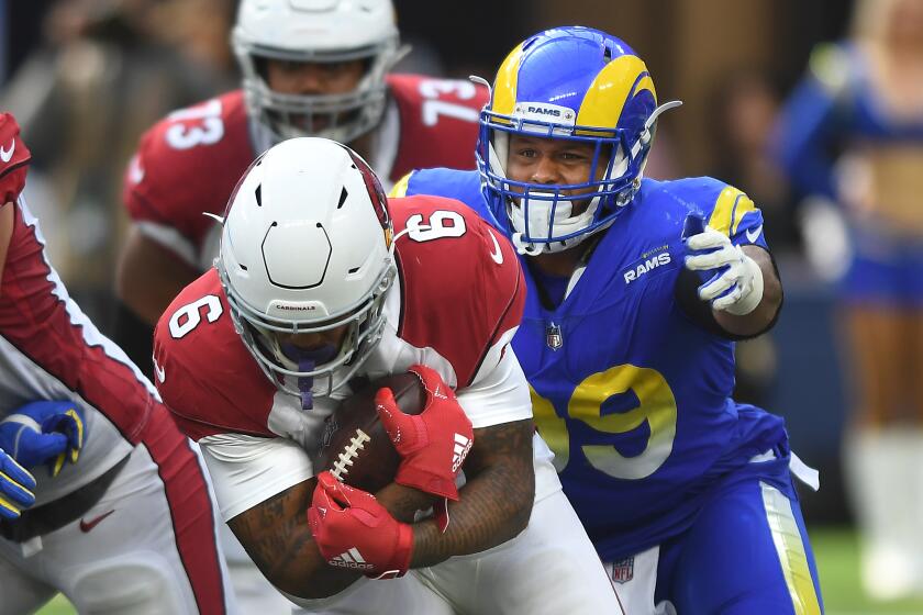 Inglewood, CA. October 3, 2021: Rams Aaron Donald prepares to tackle Cardinals running back James Conner.