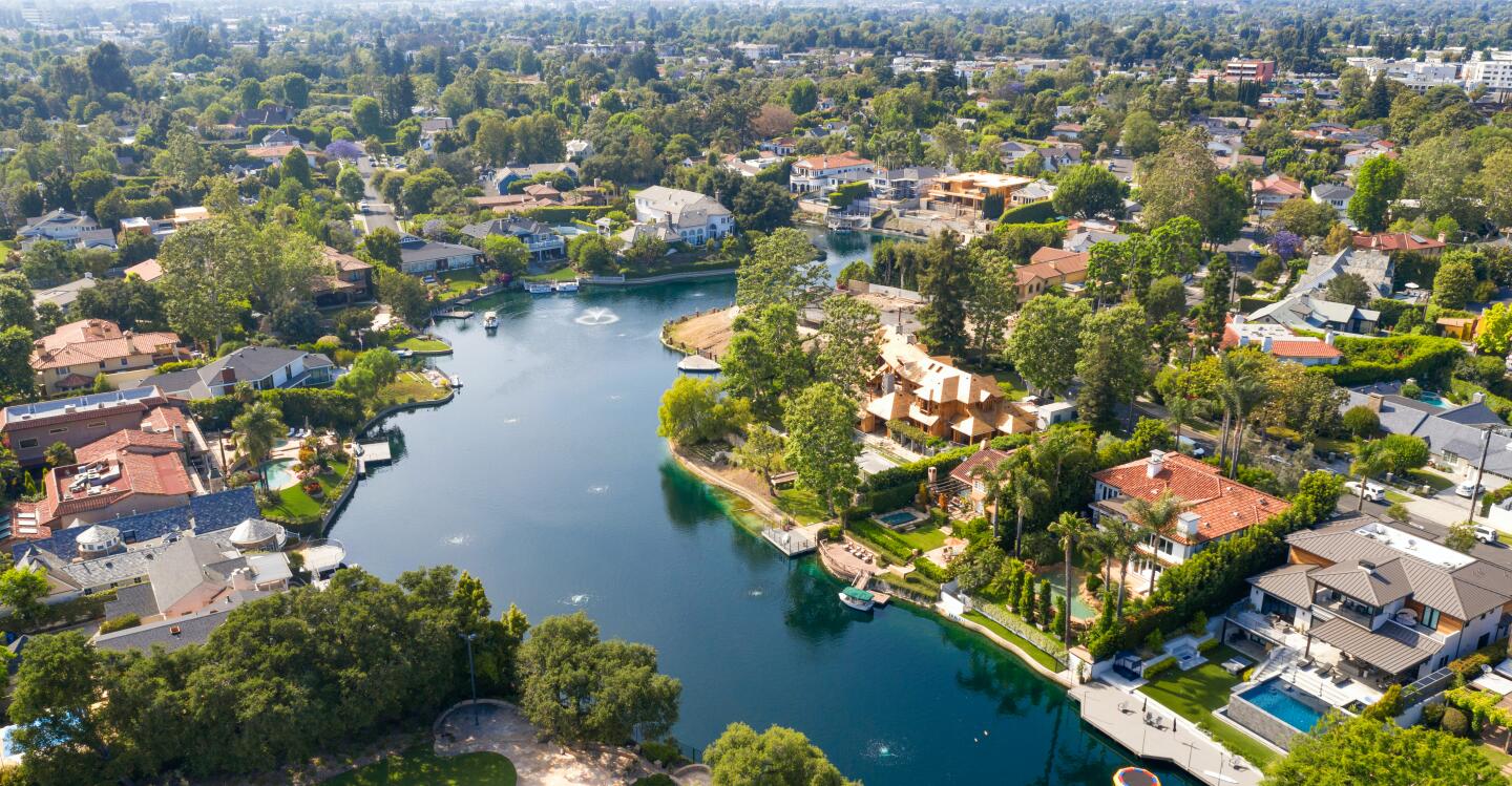The waterfront home features a dock on Toluca Lake, as well as a swimming pool, spa, gym and professional recording studio.