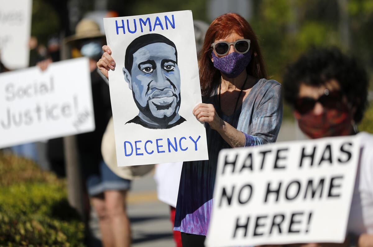 Cyndee Whitney, 73, joins a protest in support of Black Lives Matter along El Toro Road in Laguna Woods.