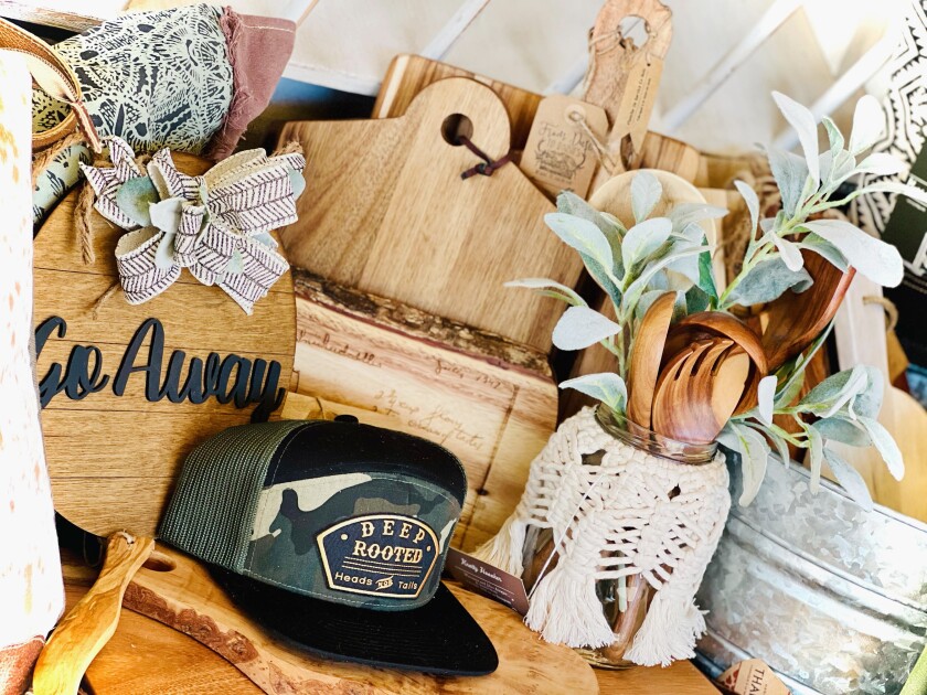 Signs, cutting boards, macrame items, hats and clothing are some of the merchandise sold at The Rusted Poppy.