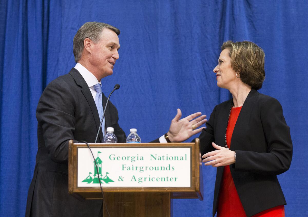 David Perdue, the Republican candidate for U.S. Senate in Georgia, talks with his Democratic opponent, Michelle Nunn, after a debate this month in Perry, Ga.