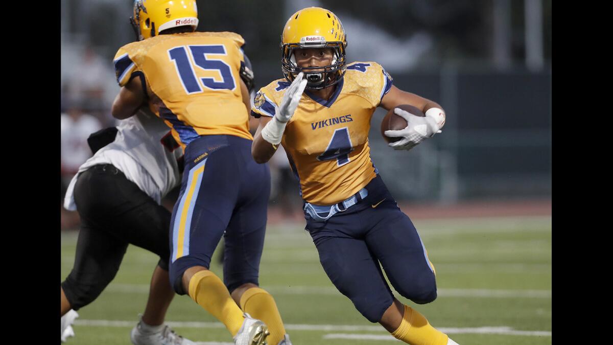 Marina running back Pharoah Rush carries the ball against Katella during the first half of a nonleague game at Westminster High on Sept. 7, 2018.