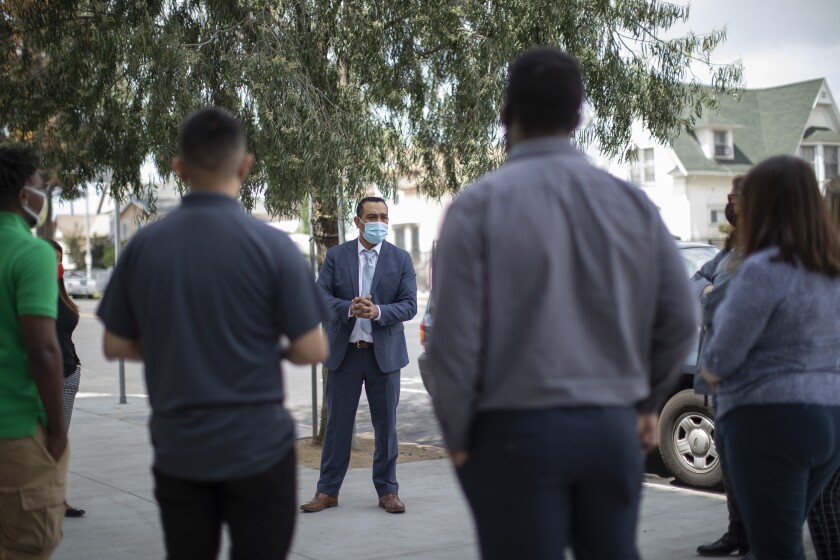 Alejandro Martinez speaks with team members