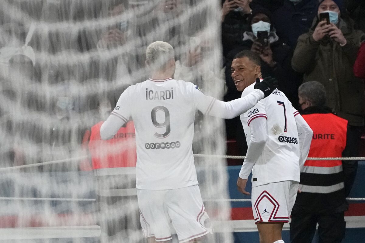 PSG's Kylian Mbappe, right, celebrates with his teammate Mauro Icardi after scoring his side's opening goal during the French League One soccer match between Paris Saint Germain and Rennes at the Parc des Princes stadium in Paris, Friday, Feb. 11, 2022. (AP Photo/Michel Euler)