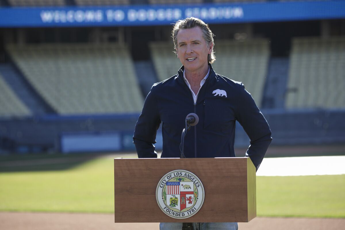 Gov. Gavin Newsom holds a news conference at the launch of COVID-19 vaccinations at Dodger Stadium on Jan. 15.