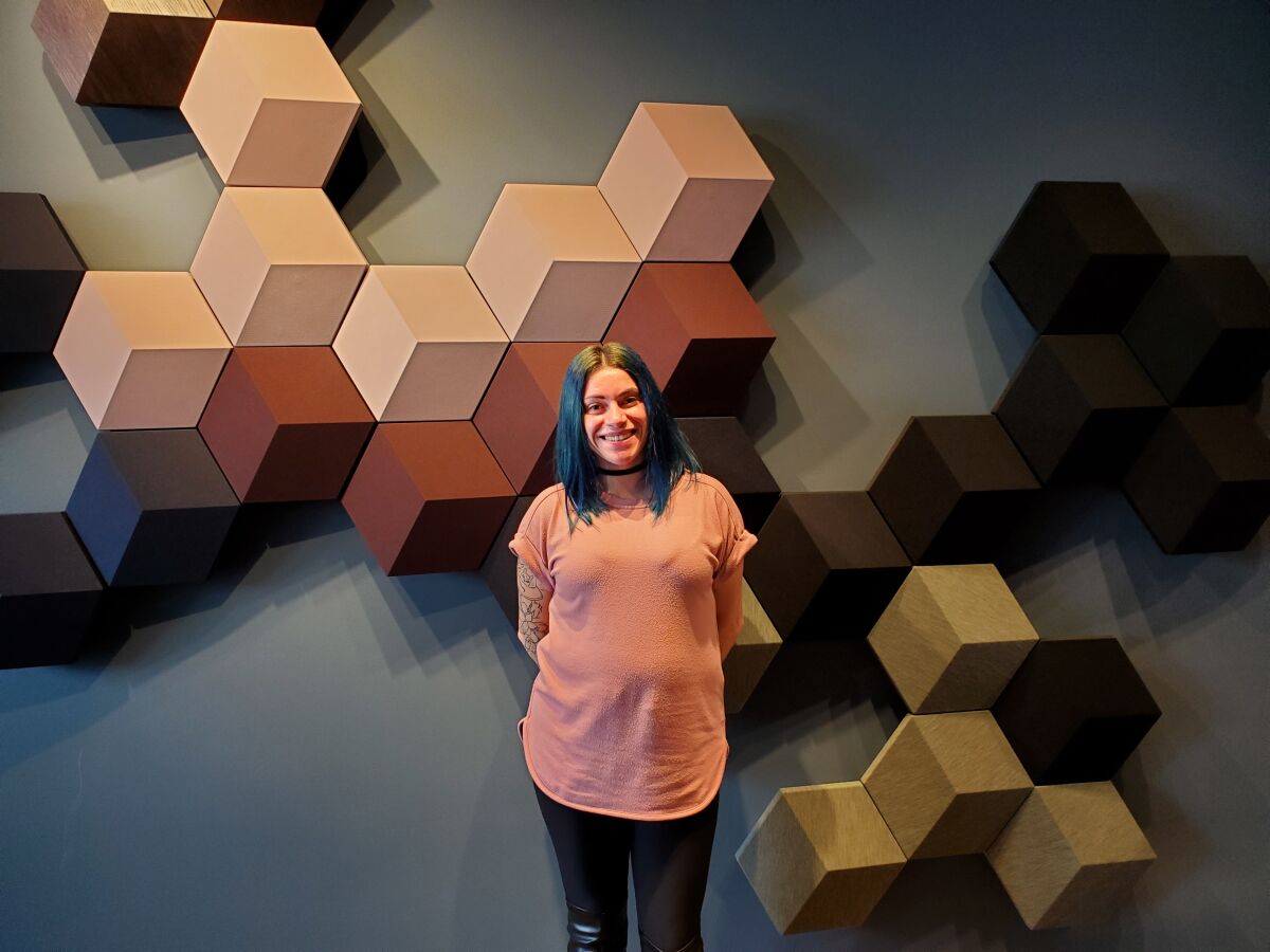 Bang & Olufsen store manager Nicole Perez stands in front of an in-home speaker system available in the La Jolla store.
