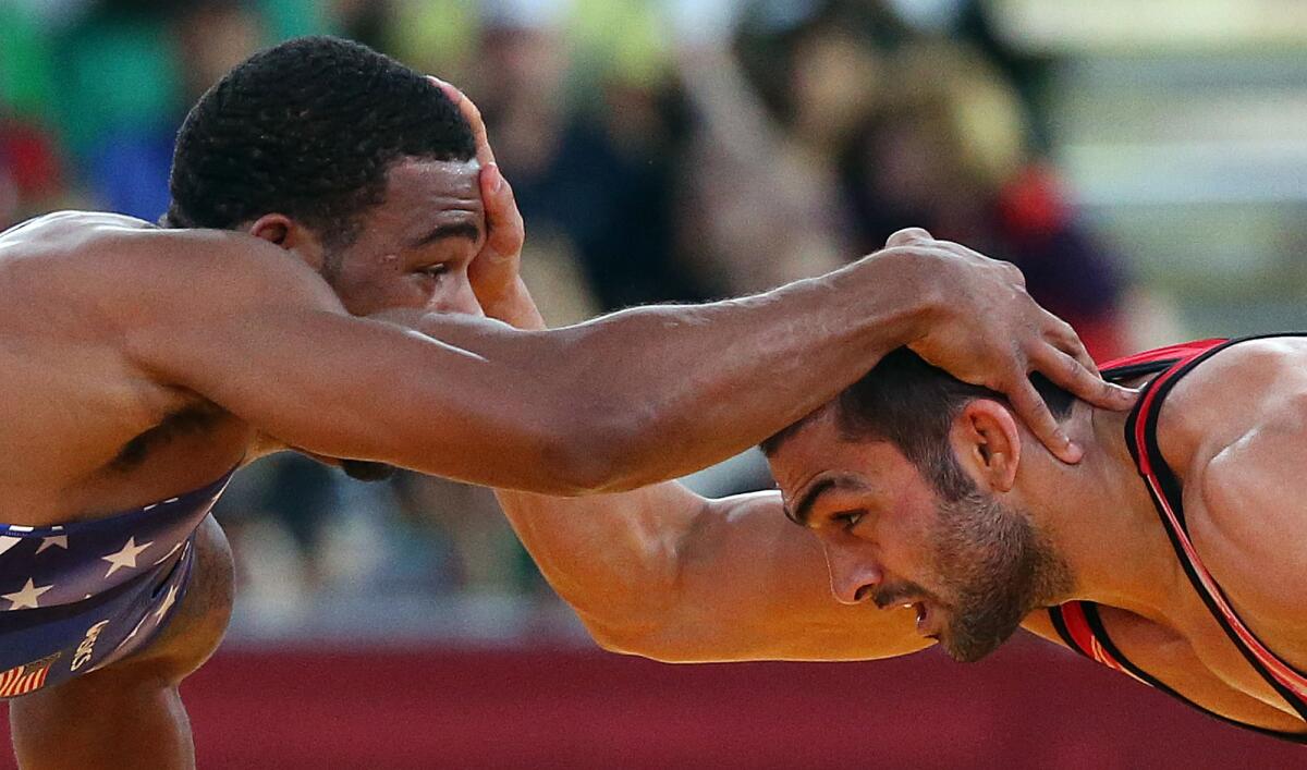 U.S. wrestler Jordan Burroughs, left, and Iran's Sadegh Saeed face off at the men's 74kg freestyle wrestling gold medal match at the London 2012 Olympics.