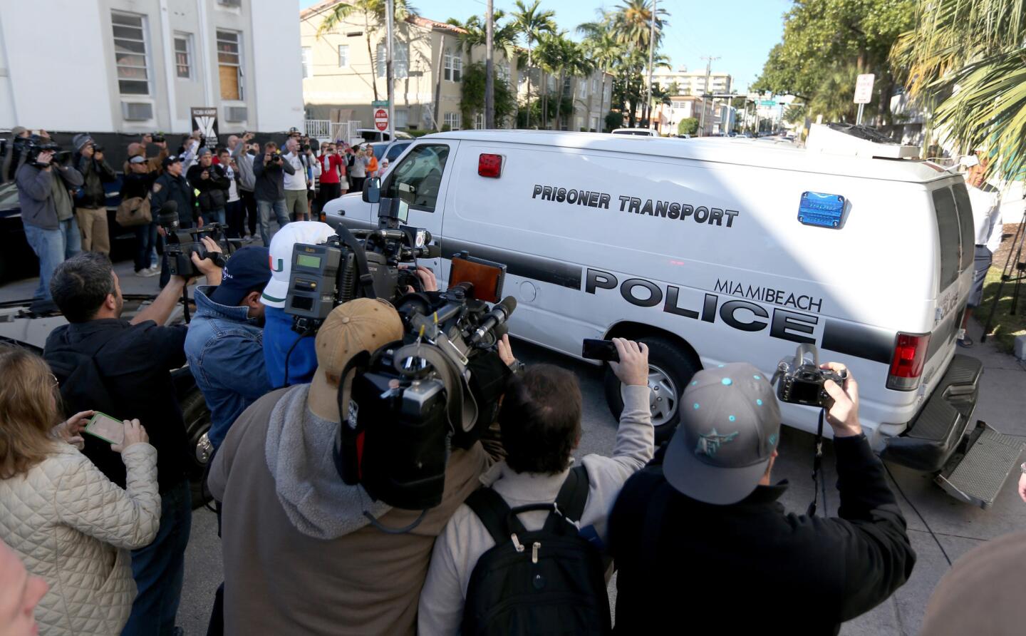 A police van leaves the Miami Beach, Fla., police station to take singer Justin Bieber to jail.