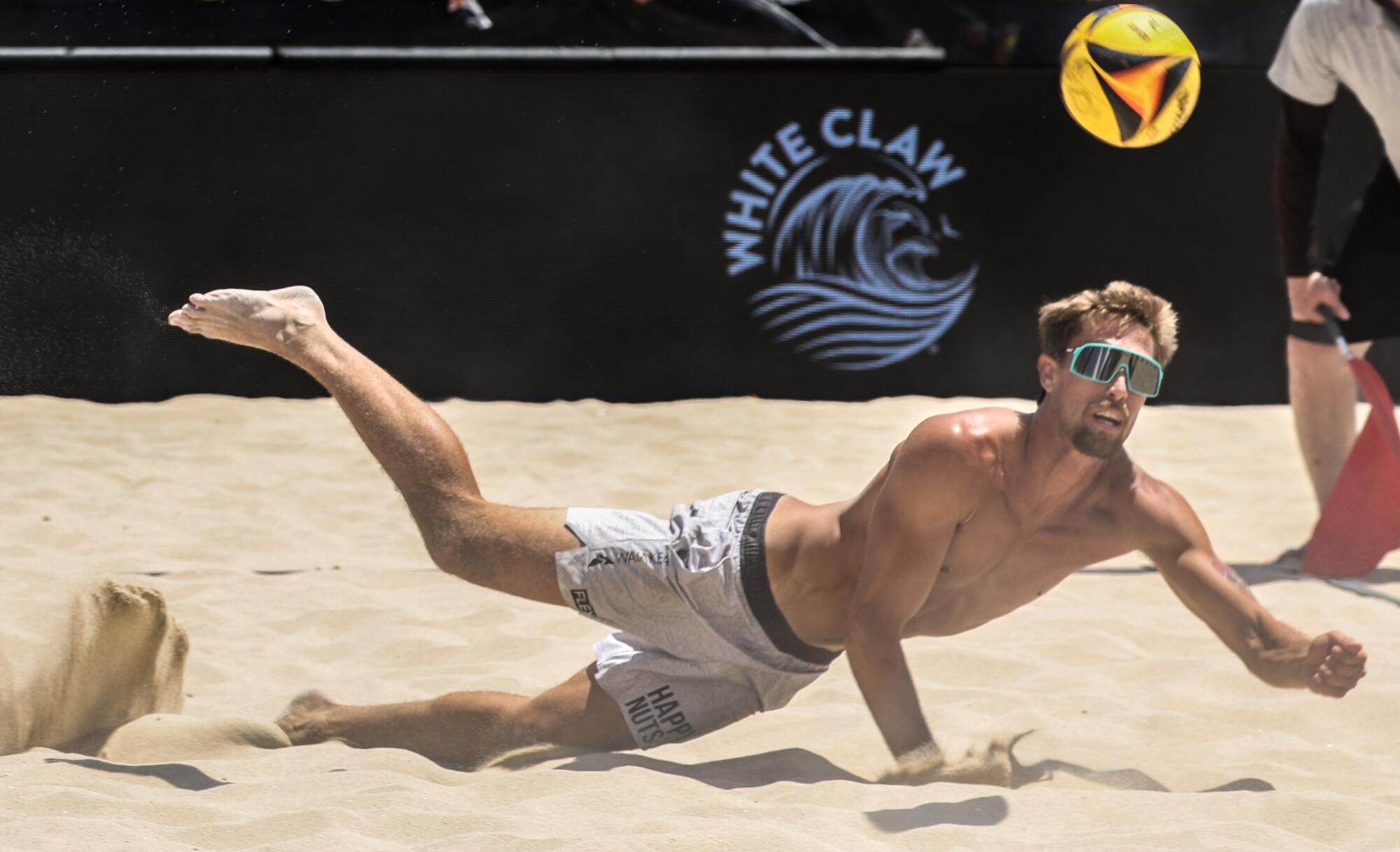 Taylor Crabb dives for a save during a match at the AVP Hermosa Beach Open.