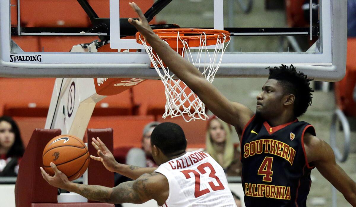 USC forward Chimezie Metu (4) defends as Washington State guard Charles Callison (23) puts up a shot in the second half on Friday.